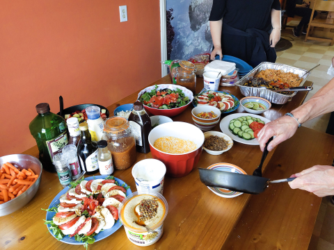 delicious dinner spread with salads, cheese and hummus
